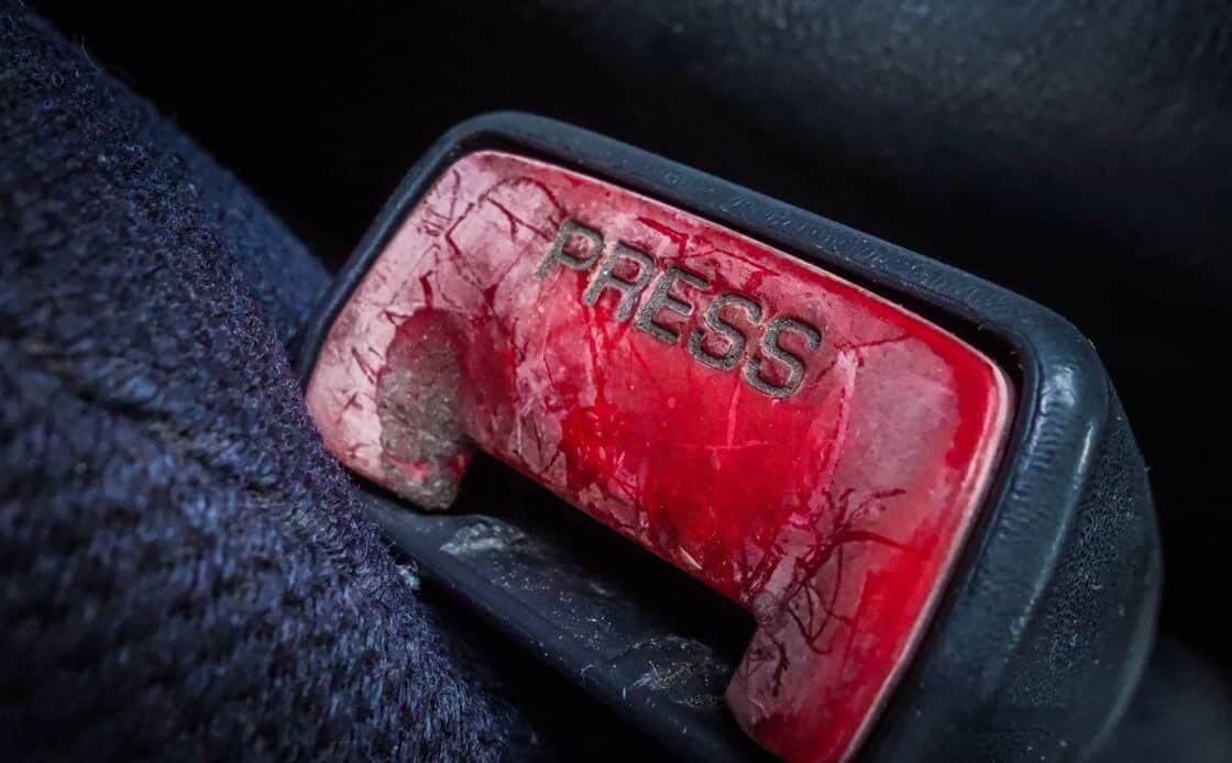 https://www.safetyrestore.com/blog/wp-content/uploads/2023/04/old-seat-belt-press-button.jpg